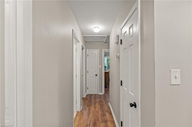 hallway with light hardwood / wood-style flooring