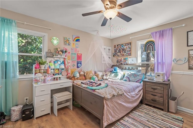 bedroom with ceiling fan and light hardwood / wood-style floors