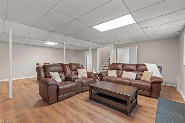 living room with hardwood / wood-style floors and a drop ceiling