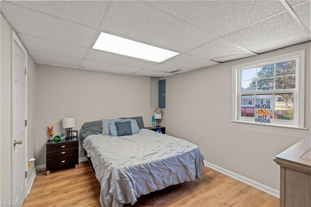 bedroom featuring a paneled ceiling and wood-type flooring