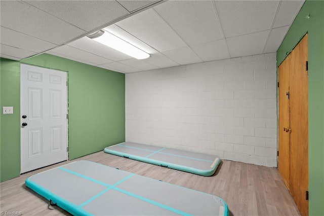 bedroom featuring light hardwood / wood-style flooring and a paneled ceiling