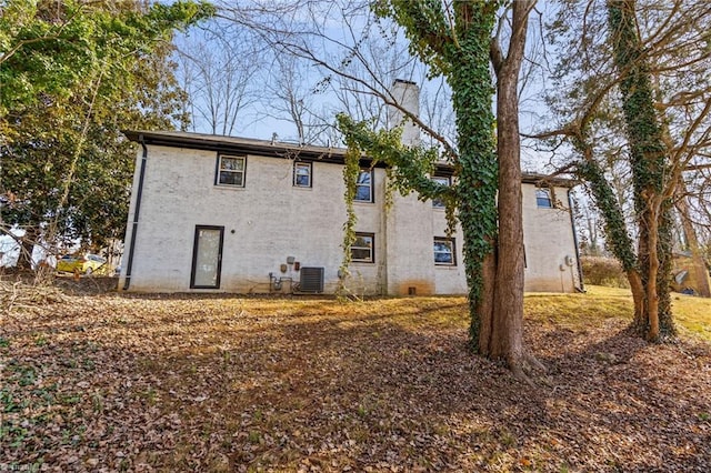 back of house with central air condition unit