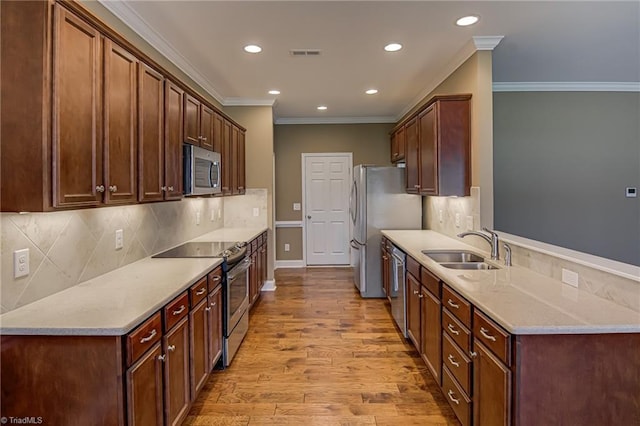 241 Collingswood Dr, Winston-Salem, NC 27127 - kitchen featuring stainless steel appliances, crown molding, a sink, light wood finished floors, and recessed lighting