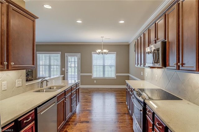 241 Collingswood Dr, Winston-Salem, NC 27127 - kitchen featuring appliances with stainless steel finishes, a sink, dark wood-type flooring, a chandelier, and tasteful backsplash