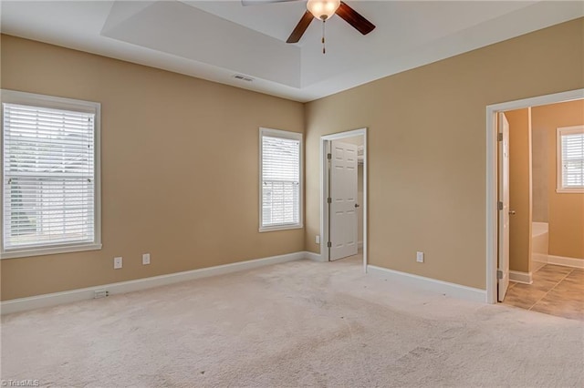 241 Collingswood Dr, Winston-Salem, NC 27127 - unfurnished bedroom with carpet flooring, a tray ceiling, baseboards, and ensuite bath