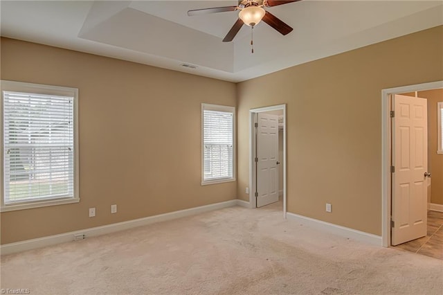 241 Collingswood Dr, Winston-Salem, NC 27127 - unfurnished bedroom with multiple windows, light colored carpet, and a raised ceiling