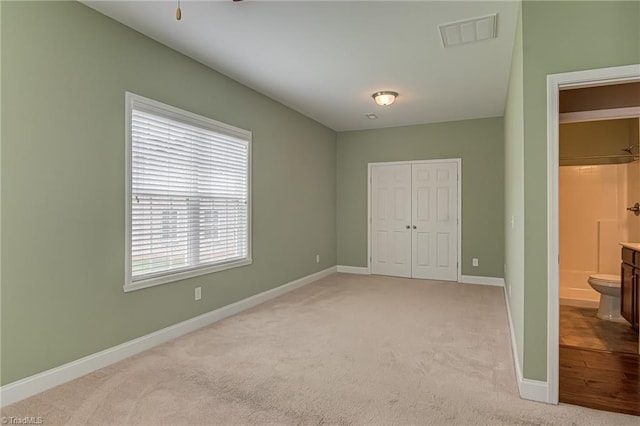 241 Collingswood Dr, Winston-Salem, NC 27127 - unfurnished bedroom featuring light colored carpet, a closet, and baseboards