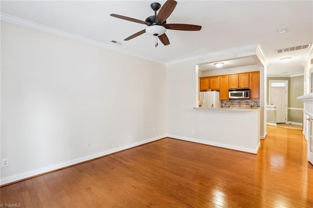 unfurnished living room featuring crown molding, ceiling fan, and light hardwood / wood-style floors