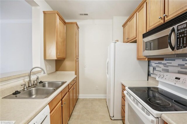 kitchen featuring sink, crown molding, white appliances, decorative backsplash, and light tile patterned floors