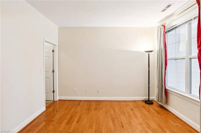 spare room featuring plenty of natural light and light wood-type flooring