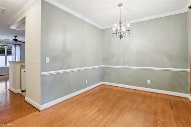 spare room with ceiling fan with notable chandelier, wood-type flooring, and crown molding