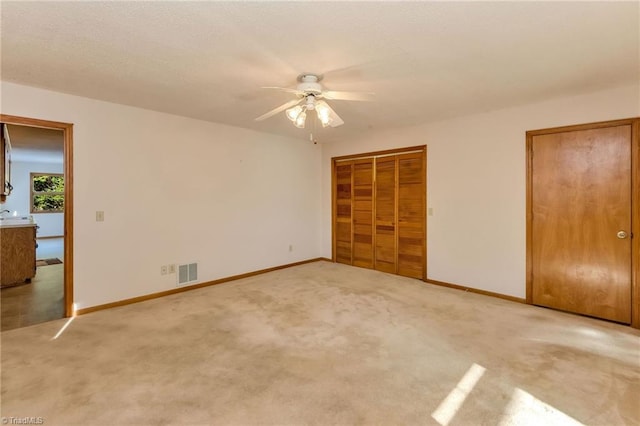 unfurnished bedroom with carpet floors and ceiling fan