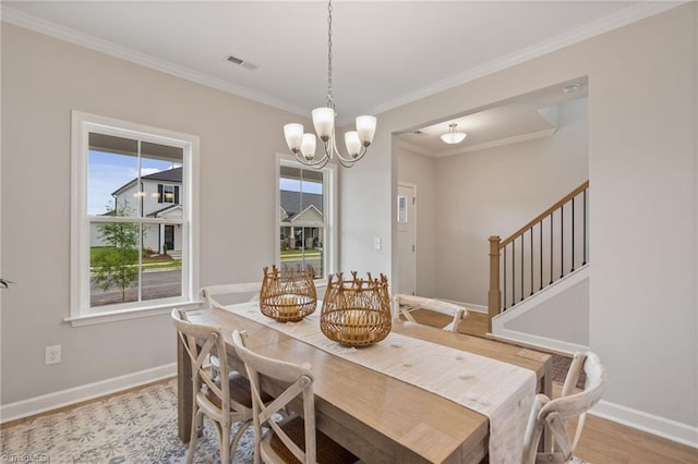 1416 Prospect Hill St, Kernersville, NC 27284 - dining space featuring plenty of natural light, a chandelier, crown molding, wood finished floors, and baseboards