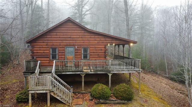 back of property featuring a wooden deck