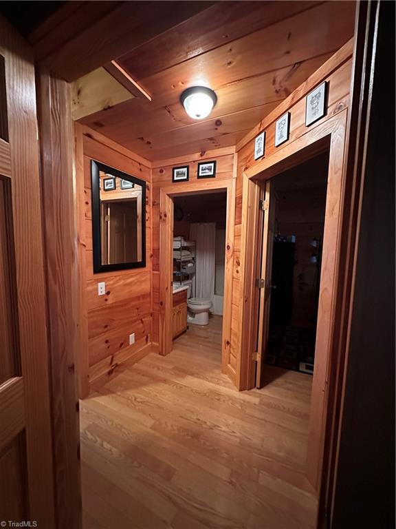 corridor with wooden walls and wood ceiling