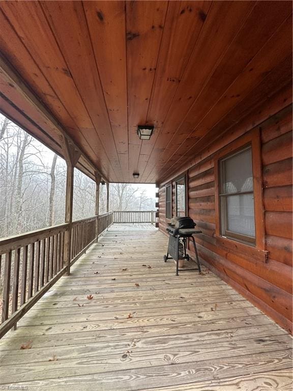 wooden terrace with a porch and grilling area