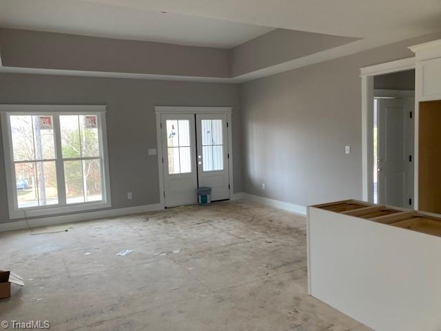 unfurnished room featuring a tray ceiling