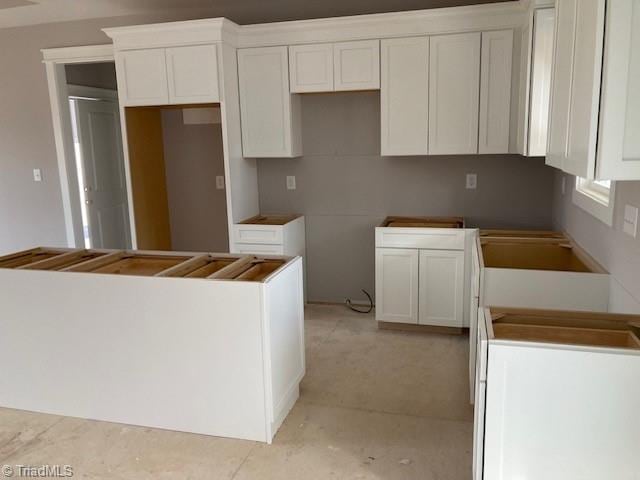 kitchen with white cabinets and a center island