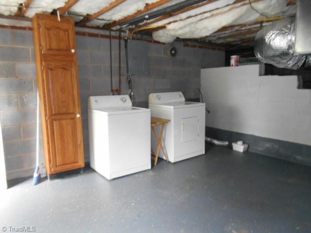 unfinished basement with washing machine and clothes dryer