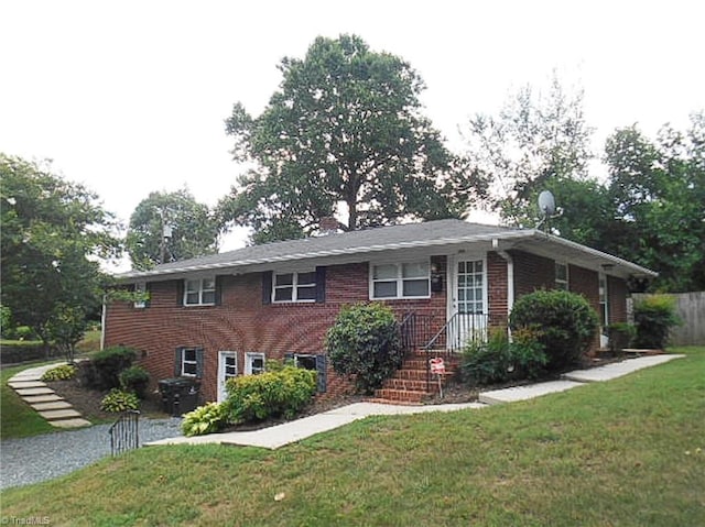 view of front of home with brick siding and a front yard