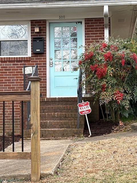 entrance to property with brick siding