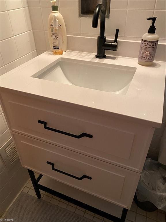 room details featuring decorative backsplash and vanity