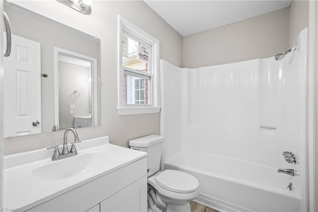 full bathroom with shower / bathing tub combination, vanity, toilet, and hardwood / wood-style floors