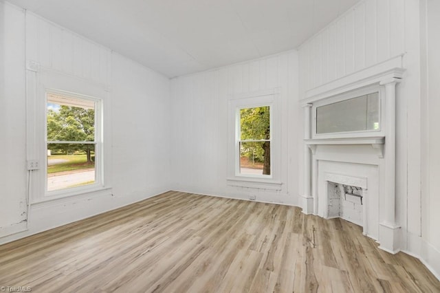 1524 E 14th St, Winston-Salem, NC 27105 - unfurnished living room with light wood finished floors, healthy amount of natural light, and a large fireplace