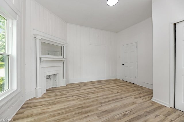 1524 E 14th St, Winston-Salem, NC 27105 - unfurnished living room featuring healthy amount of natural light, light wood-type flooring, and a fireplace