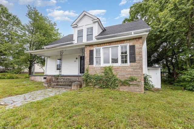 1524 E 14th St, Winston-Salem, NC 27105 - bungalow-style house featuring stone siding, a front lawn, covered porch, and a shingled roof