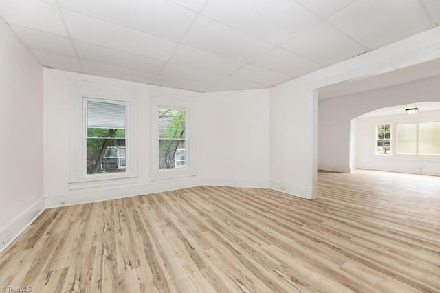 1524 E 14th St, Winston-Salem, NC 27105 - unfurnished room featuring a paneled ceiling, plenty of natural light, light wood-type flooring, and arched walkways
