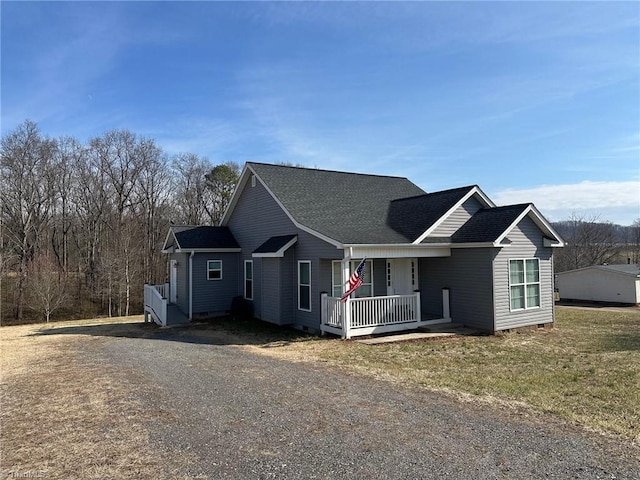 view of front of property with a porch and a front lawn