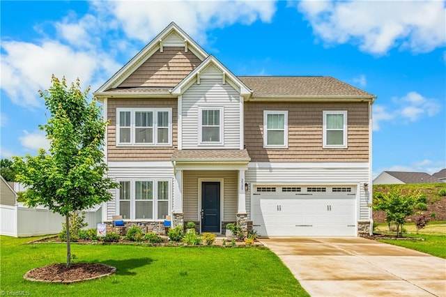 craftsman house with a garage, stone siding, and driveway