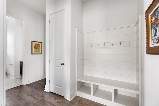 mudroom with dark wood-style floors and baseboards