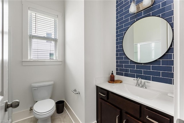 bathroom with baseboards, toilet, vanity, and tile patterned floors