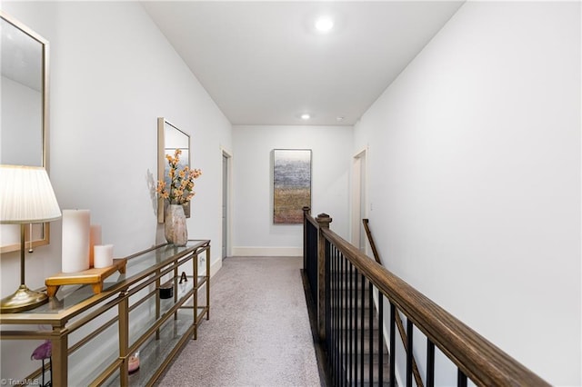 hallway with an upstairs landing, carpet, recessed lighting, and baseboards