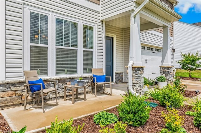 view of patio with a garage and covered porch