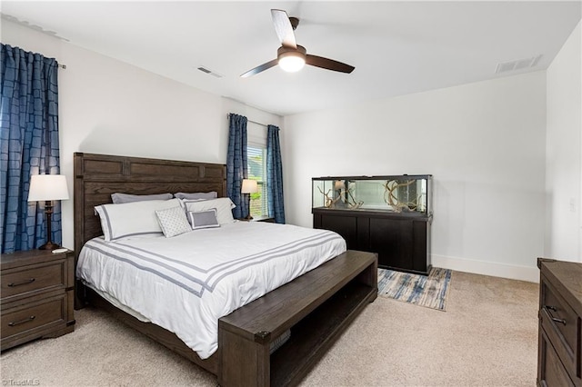 bedroom featuring light carpet, baseboards, and ceiling fan