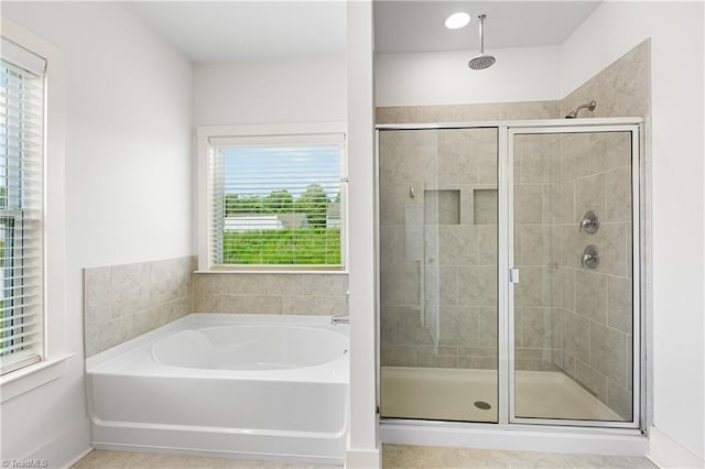 bathroom with a shower stall and a bath