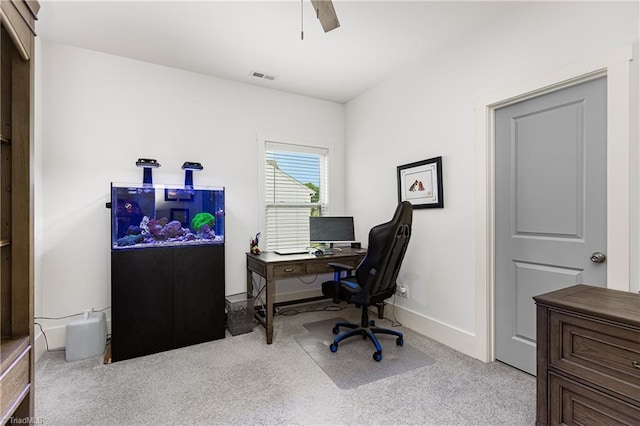 carpeted office featuring ceiling fan and baseboards
