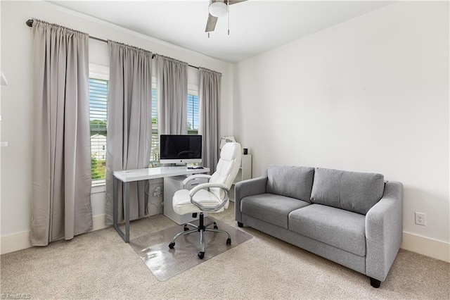 carpeted home office featuring plenty of natural light, a ceiling fan, and baseboards