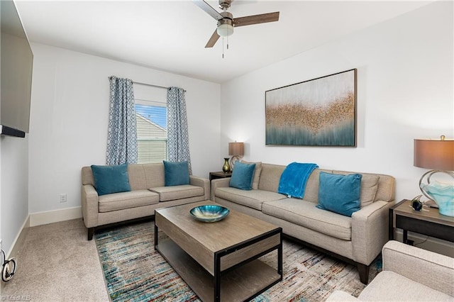 living area with a ceiling fan, carpet flooring, and baseboards