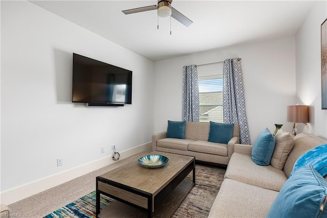 carpeted living room with a ceiling fan and baseboards