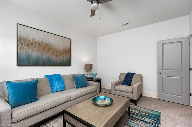 living room with ceiling fan, carpet, and baseboards