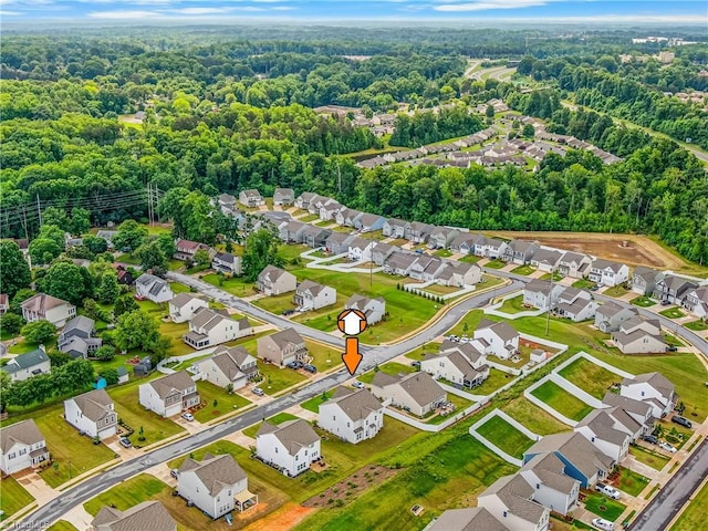 aerial perspective of suburban area with a heavily wooded area