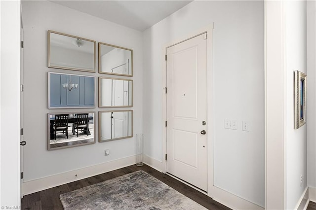 entrance foyer featuring dark wood-style flooring and baseboards