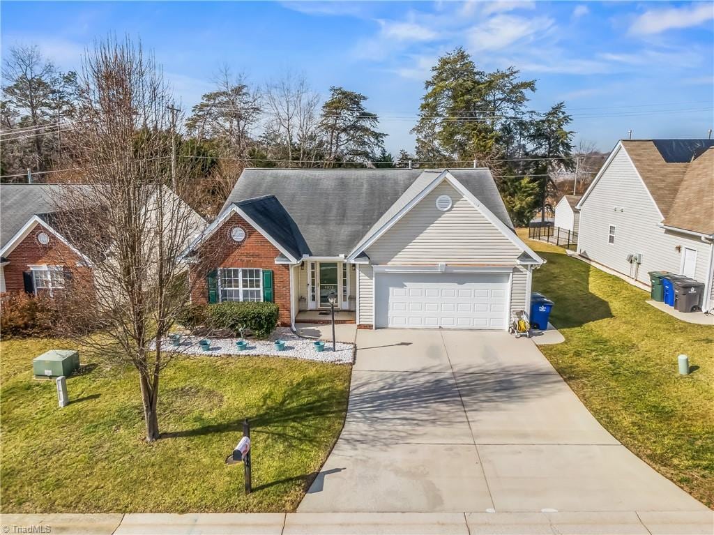 view of front of home with a garage and a front lawn