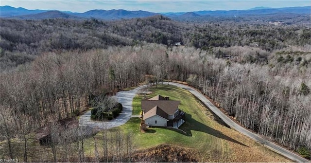 drone / aerial view featuring a forest view and a mountain view