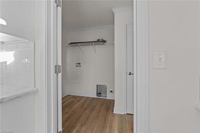 washroom featuring crown molding, baseboards, washer hookup, laundry area, and wood finished floors