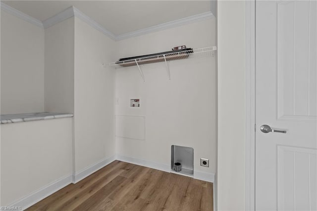 clothes washing area with electric dryer hookup, hookup for a washing machine, laundry area, and crown molding